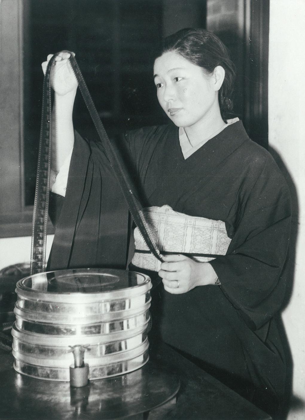 Kashiko Kawakita examining a film print, circa 1932.